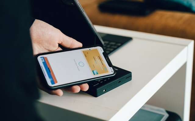 Contactless payment with a phone, illustrative photo