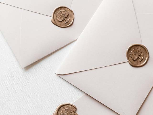 Gold wax seals on envelopes, illustrative photo