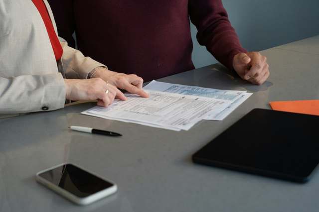 Employment document being reviewed on a desk, illustrative photo