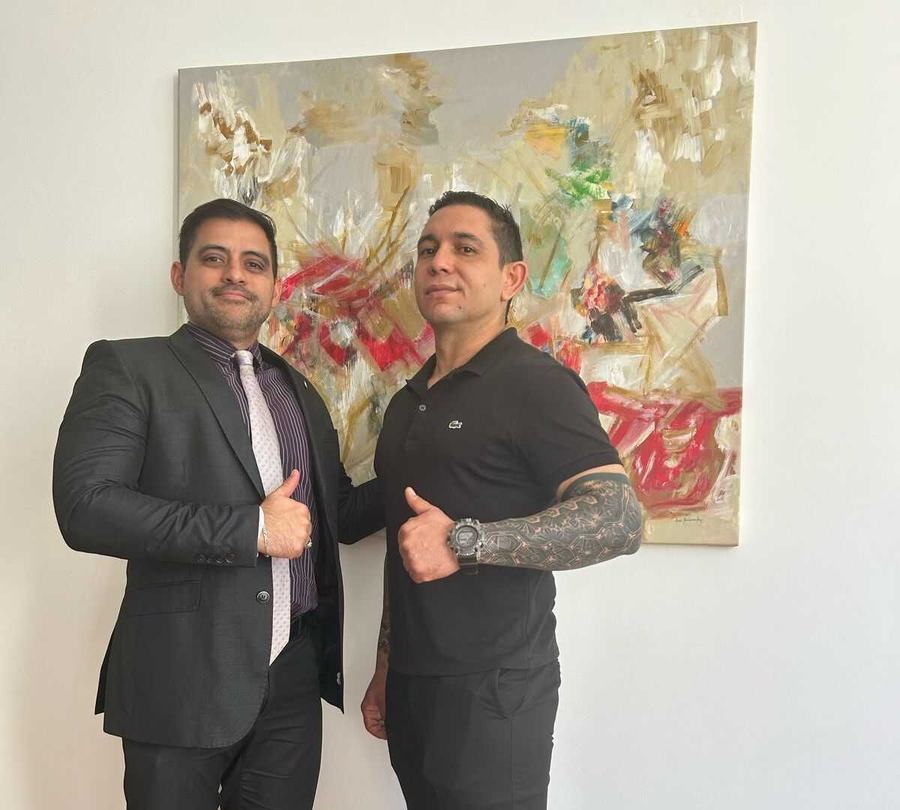 Dr. Portillo with a client at the firm's office, photo from the firm